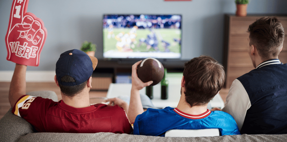 Three men with American football equipment