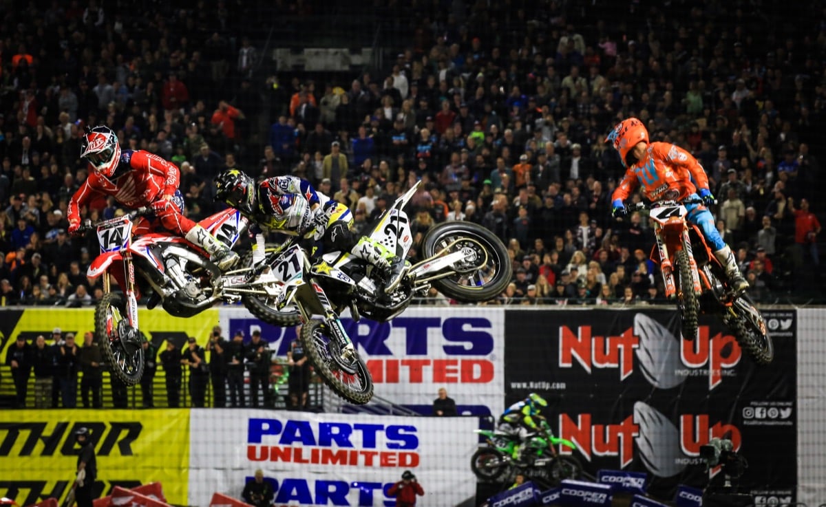 Motocross race with sponsor logos in the background